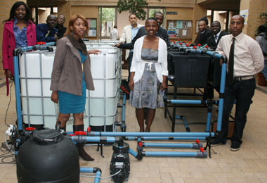 Students presenting a container-based fish farming system prototype