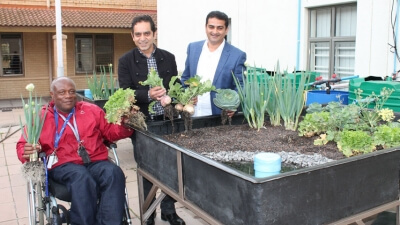 Community members and researchers demonstrating the solar-powered aquaponics farming system